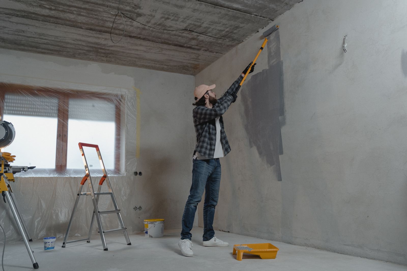 A Patriot Painting crew member rolling a smooth even coat onto an interior feature wall